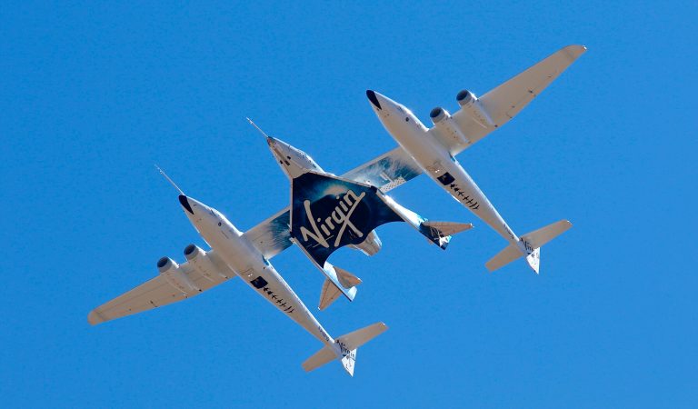 FILE - In this Feb. 13, 2020, file photo, Virgin Galactic's VSS Unity departs Mojave Air & Space Port in Mojave, Calif., for its SpaceFlight operations to New Mexico. (Matt Hartman via AP, File)