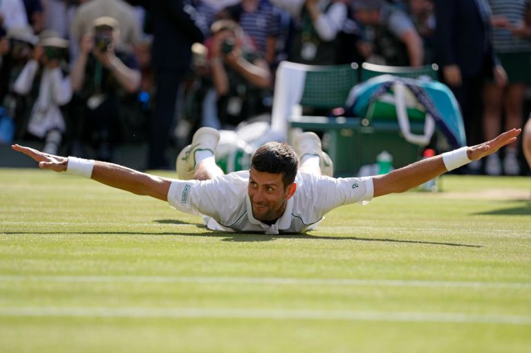 Serbia's Novak Djokovic celebrates after beating Australia's Nick Kyrgios to win the final of Wimbledon's men's singles in London, Sunday, July 10, 2022.