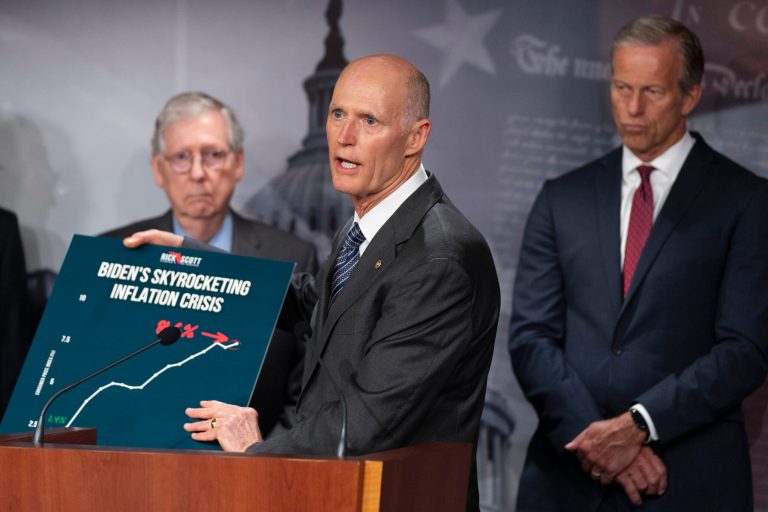 Sen. Rick Scott, R-Fla., with Senate Minority Leader Mitch McConnell of Ky., left, and Sen. John Thune, R-S.D., holds up a graph as he speaks during a news conference following the Republican policy luncheon, on Capitol Hill, Tuesday, July 12, 2022, in Washington. Scott said Sunday the GOP's focus for the 2022 midterms will be on inflation, not former President Donald Trump. (AP Photo/Manuel Balce Ceneta)