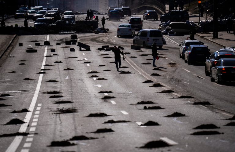 Cars are stopped at a roadblock set by civil defensemen at a road leading to central Kyiv, Ukraine, on Feb. 28. 