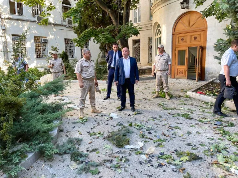 Governor of Sevastopol Mikhail Vladimirovich Razvozhayev, center, stands at the scene of explosion at the headquarters of Russia's Black Sea Fleet in Sevastopol, Crimea.