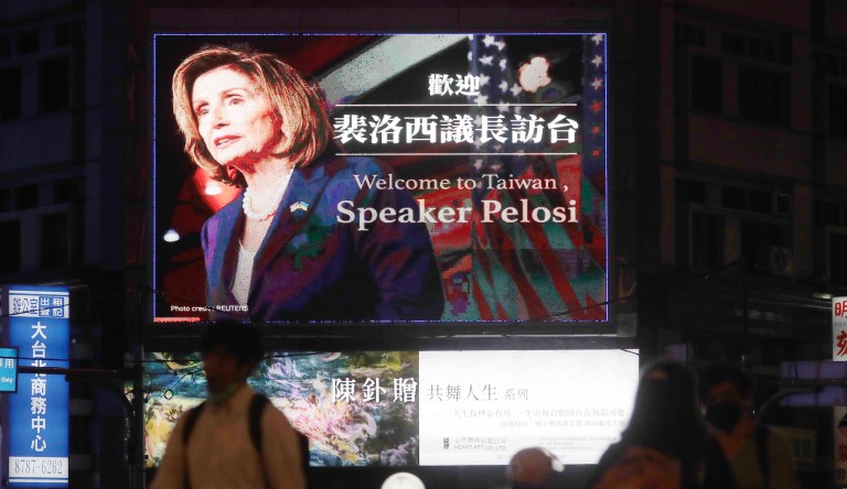 People walk past a billboard welcoming U.S. House Speaker Nancy Pelosi, in Taipei, Taiwan, on Tuesday.
