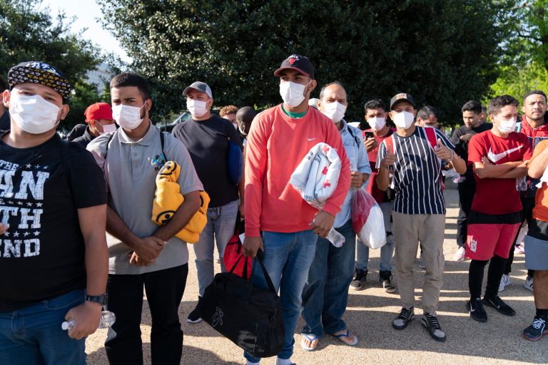 FILE - Migrants hold Red Cross blankets after arriving at Union Station near the U.S. Capitol from Texas on buses, April 27, 2022, in Washington. A new poll from Gallup released August 8, 2022 found that 38% of people in the United States want less immigration, while 27% said they want more, and another 31% said they want immigration to remain at its current level. (AP Photo/Jose Luis Magana, File)