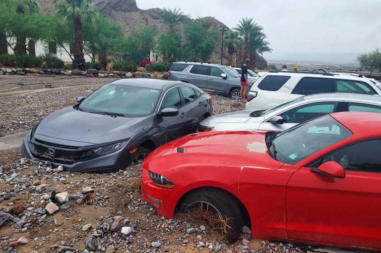Cars are stuck in mud and debris from flash flooding at The Inn at Death Valley in Death Valley National Park, Calif., Friday, Aug. 5, 2022.