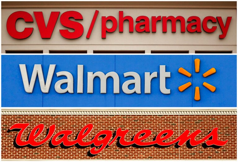 This undated combination of file photos show the signs of CVS, Walmart and Walgreens.