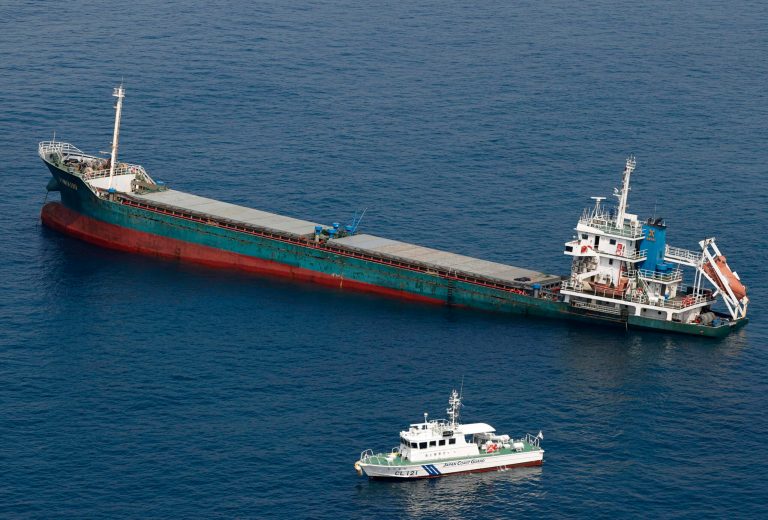 This aerial photo shows Belize-registered cargo ship Xin Hai 99, after a collision, off Kushimoto, Wakayama prefecture, southwestern Japan, Saturday, Aug. 20, 2022. A Japanese chemical tanker ship crashed into the cargo ship off the coast of southwestern Japan, the coast guard said Saturday.