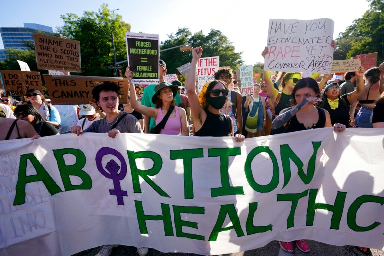 FILE - Demonstrators march and gather near the Texas state Capitol in Austin following the Supreme Court's decision to overturn Roe v. Wade on June 24, 2022. A federal judge in Texas issued a ruling on Tuesday, Aug. 23, 2022, temporarily blocking the federal government from enforcing guidance against the state that requires hospitals to provide abortion services if the life of the mother is at risk.
