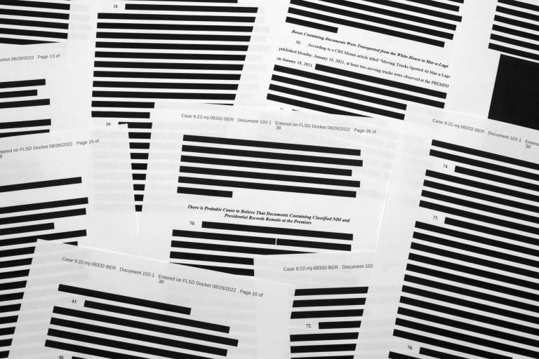 Pages from the affidavit by the FBI in support of obtaining a search warrant for former President Donald Trump's Mar-a-Lago estate are photographed on Friday.