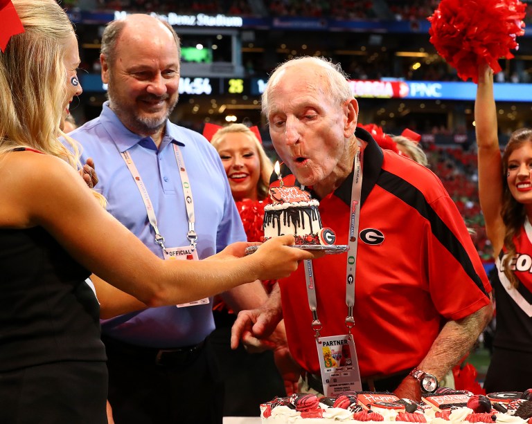 Former Georgia head coach Vince Dooley blows out a candle after getting a surprise birthday celebration before the Bulldogs' kickoff against Oregon Atlanta, Saturday, Sept. 3, 2022. 