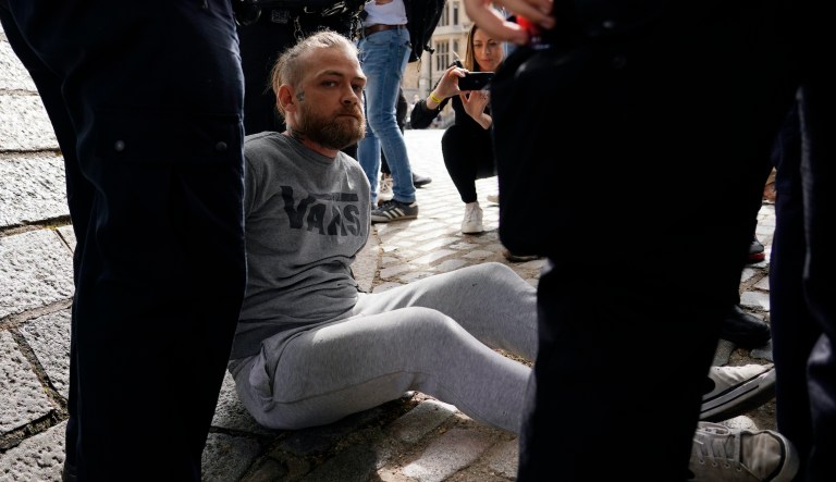 Police officers detain a protester before the announcement of the result of the Conservative Party leadership contest, near the Queen Elizabeth II centre in London, Monday, Sept. 5, 2022.