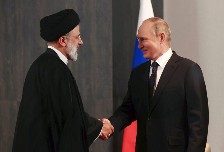 Russian President Vladimir Putin, right, and Iranian President Ebrahim Raisi shake hands during their meeting on the sidelines of the Shanghai Cooperation Organisation summit in Samarkand, Uzbekistan, on Sept. 15, 2022. 