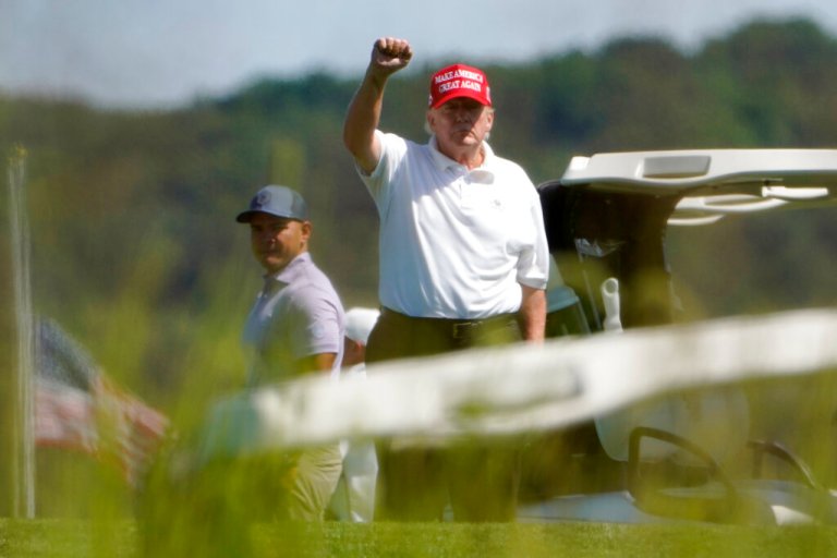 Former President Donald Trump gestures while playing golf at Trump National Golf Club in Sterling, Va., on Tuesday, Sept. 13, 2022. 