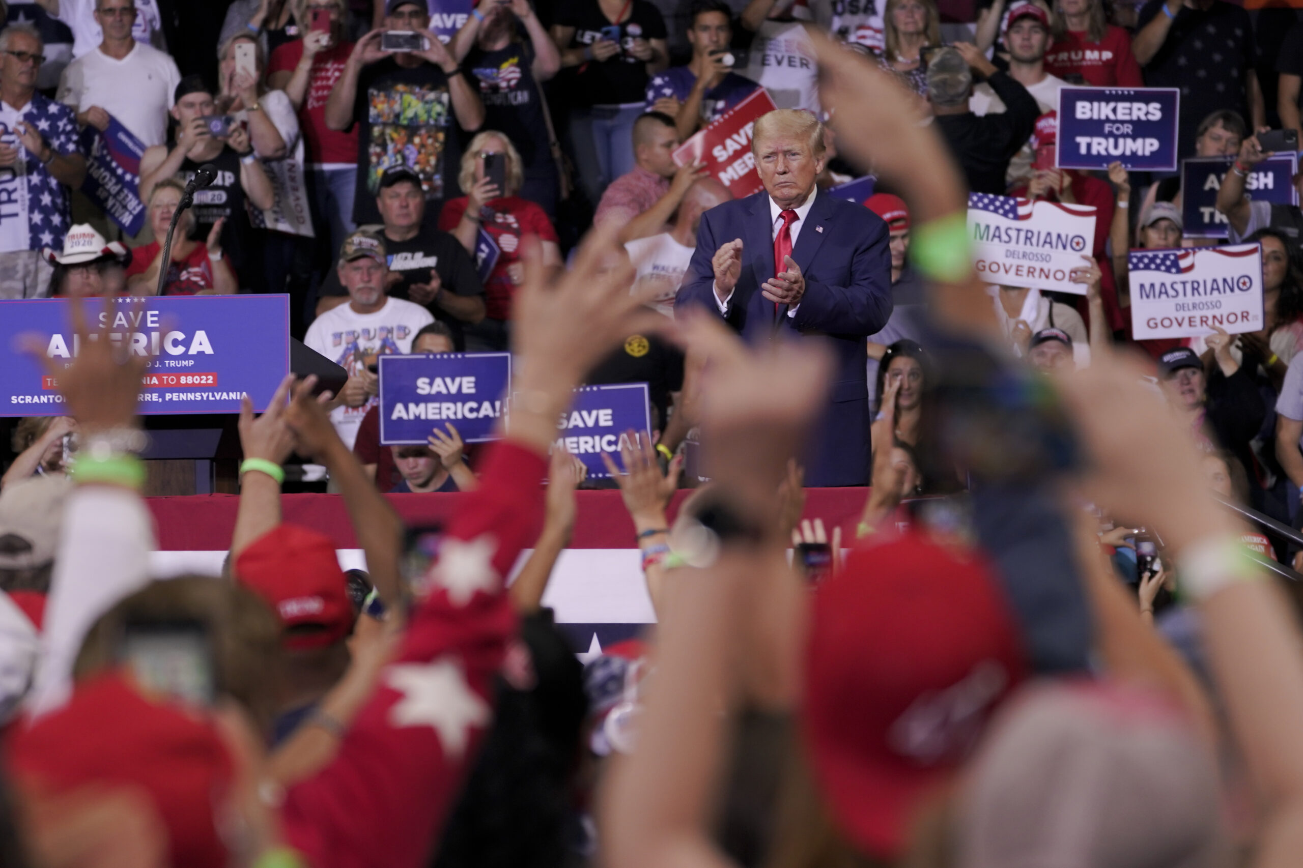 Trump rally officials appear to shut down QAnon finger salutes in video