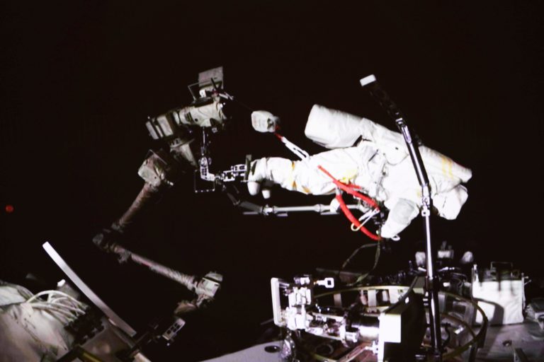 In this photo released by China's Xinhua News Agency, a screen at the Beijing Aerospace Control Center in Beijing shows Chinese astronaut Cai Xuzhe conducting extravehicular activities, also known as a spacewalk, around the space station lab module Wentian, Saturday, Sept. 17, 2022.