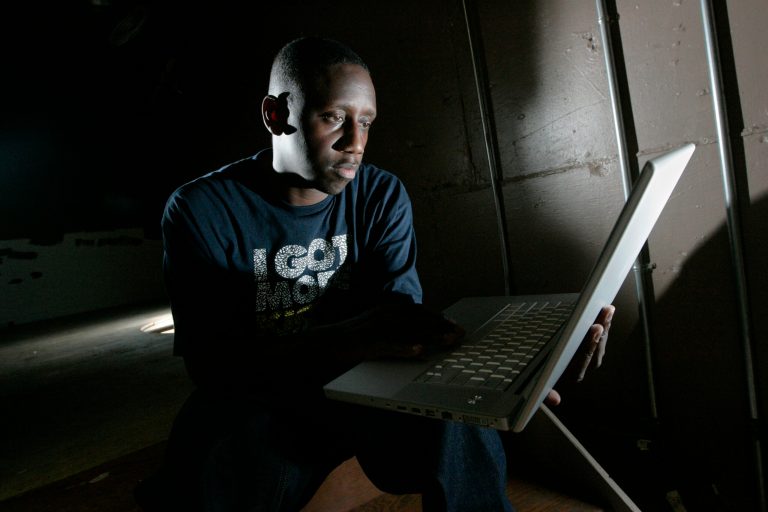 Record producer Chaka Zulu looks through material on Sept. 2, 2008, in Atlanta. Zulu, who manages rap star and actor Ludacris, faces a murder charge in Atlanta in connection with a June shooting. Police reports show that Chaka Zulu, whose legal name is Ahmed Obafemi, turned himself in to face charges Tuesday, Sept. 20, 2022.