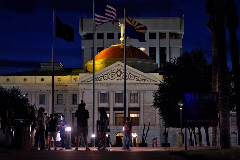 Protesters gather outside the Capitol to voice their dissent with an abortion ruling on Sept. 23 in Phoenix. An Arizona judge ruled the state can enforce a near-total ban on abortions that has been blocked for nearly 50 years. 