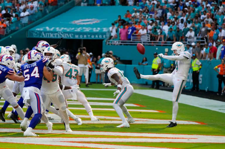 Miami Dolphins punter Thomas Morstead (4) sees the ball go backwards after attempting a punt during the second half of an NFL football game against the Buffalo Bills, Sunday, Sept. 25, 2022, in Miami Gardens, Florida. The play resulted in a safety for the Buffalo Bills.