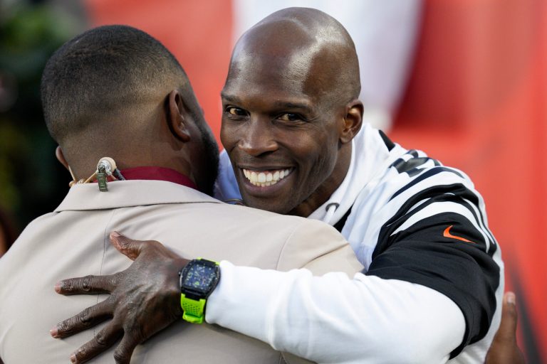 Former Cincinnati Bengals wide receiver Chad Johnson (right) embraces NFL Network analyst Cameron Wolfe during the Bengals game against the Miami Dolphins, Friday, Sept. 30, 2022, in Cincinnati.