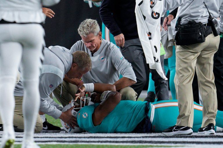 Miami Dolphins quarterback Tua Tagovailoa is attended to by medical staff after being sacked by Cincinnati Bengals defensive tackle Josh Tupou during an NFL football game, Friday, Sept. 30, 2022, in Cincinnati. 