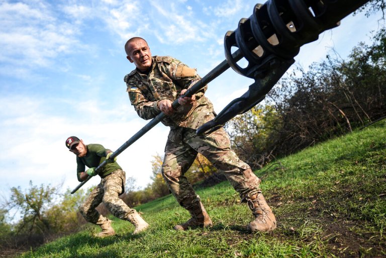 Ukrainian soldiers clean the muzzle of Ukrainian howitzer D-30 near Siversk, Donetsk region, Ukraine, Saturday, Oct. 1, 2022.