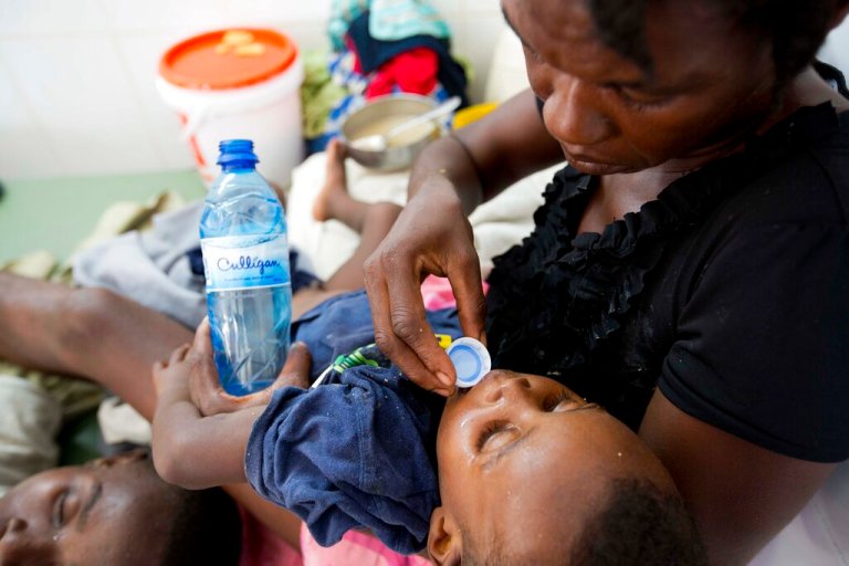 FILE - A boy diagnosed with cholera receives treatment at a cholera center in Anse D'Hainault, Haiti, Tuesday, Oct. 11, 2016.