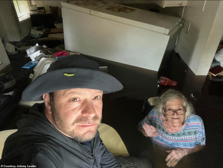Johnny Lauder takes a selfie with his mother, Karen Lauder, as he came to rescue her after water flooded her home, in Naples, Florida, Wednesday, Sept. 28, 2022, following Hurricane Ian. 
