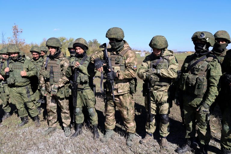 Russian army recruits listen to an instructor during a military training at a firing range in Donetsk People's Republic controlled by Russia-backed separatists, eastern Ukraine, Wednesday, Oct. 5, 2022. Miss Crimea 2022, Olga Valeyena, and a friend of hers were punished after singing a popular Ukrainian anthem. (AP Photo/Alexei Alexandrov)
