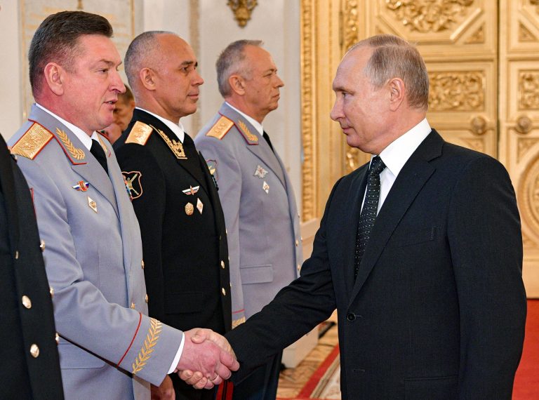 Russian President Vladimir Putin, right, and Lt. Gen. Alexander Lapin, the chief of Russia's Central Military District, left, attend an awarding ceremony in the Kremlin in Moscow, Russia, on May 31, 2018.