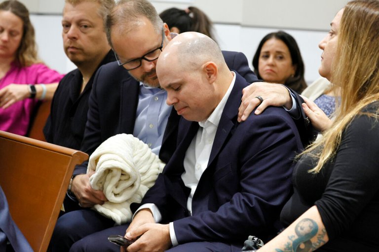 Ryan Petty comforts Ilan Alhadeff as they await the verdict in the trial of Marjory Stoneman Douglas High School shooter Nikolas Cruz at the Broward County Courthouse in Fort Lauderdale on Thursday, Oct. 13, 2022. Petty's daughter, Alaina, and Alhadeff's daughter, Alyssa, were killed in the 2018 shootings.