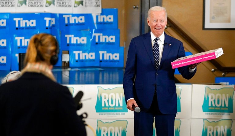 President Joe Biden holds a box of doughnuts during a grassroots volunteer event with the Oregon Democrats at the SEIU Local 49 in Portland, Ore. Friday, Oct. 14, 2022. 
