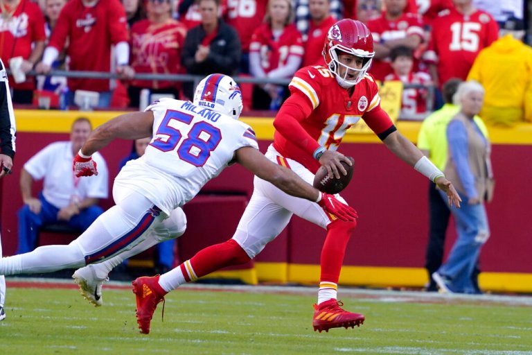 Kansas City Chiefs quarterback Patrick Mahomes (15) scrambles away from Buffalo Bills linebacker Matt Milano (58) during the first half of an NFL football game Sunday, Oct. 16, 2022, in Kansas City, Mo.