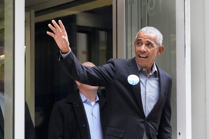 Former President Barack Obama waves to the crowd after casting his ballot at an early voting site Monday, Oct. 17, 2022, in Chicago.