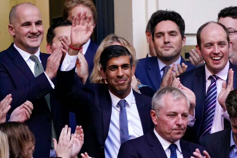 Rishi Sunak, center, waves after winning the Conservative Party leadership contest at the Conservative party Headquarters in London, Monday, Oct. 24, 2022. 