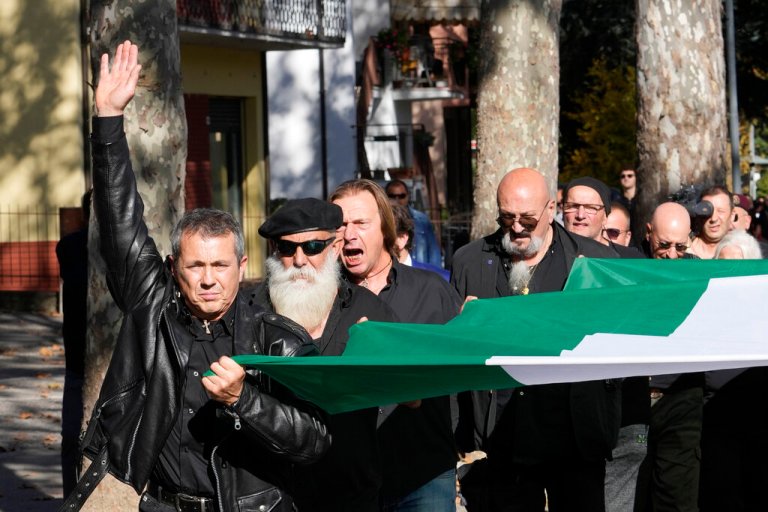 People march in the hometown of former dictator Benito Mussolini to mark the 100th anniversary of the coup d'etat by which he sized power in 1922, in Predappio, Italy, Sunday, Oct. 30, 2022.
