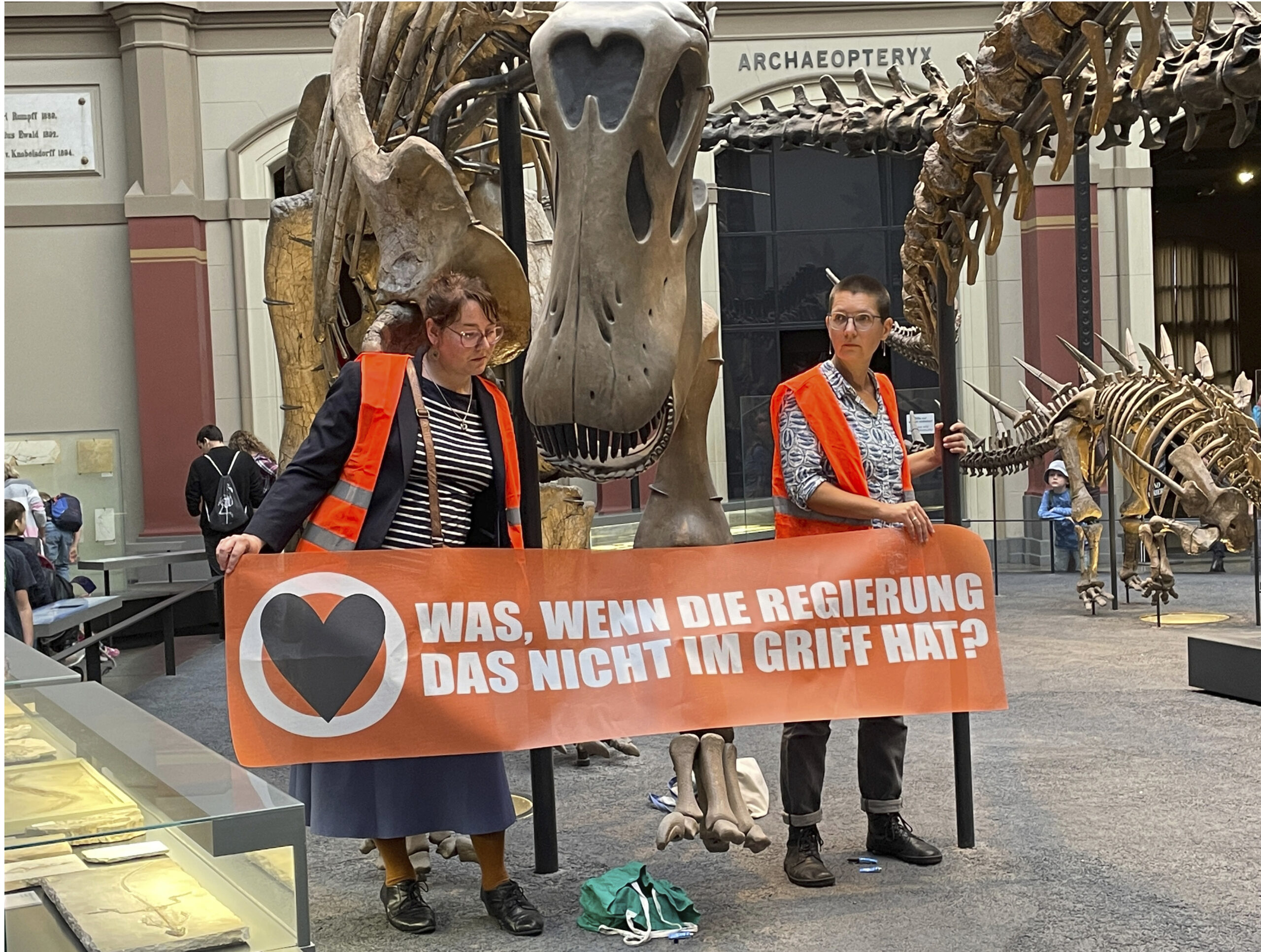 Sticky situation: German climate activists glue themselves to dinosaur display