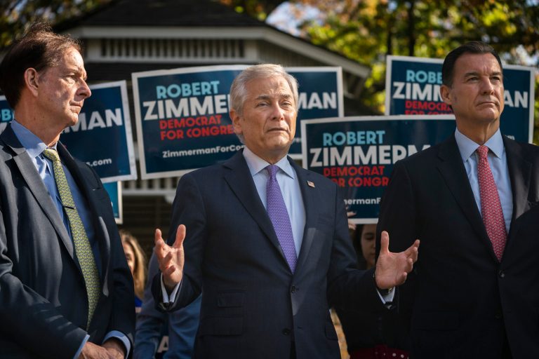 Robert Zimmerman, Democratic candidate for New York's 3rd Congressional District, center, speaks alongside Rep. Tom Suozzi (D-NY), right, and former Rep. John LeBoutillier (R-NY), left, during a news conference with a bipartisan group of current and former elected officials who support his campaign on Monday, Nov. 7, 2022, in Great Neck, New York.