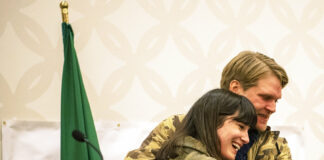 Marie Gluesenkamp Perez, left, hugs her husband Dean Gluesenkamp after delivering a speech to supporters at the Clark County Democrats election night watch party at a hotel in Vancouver, Washington.