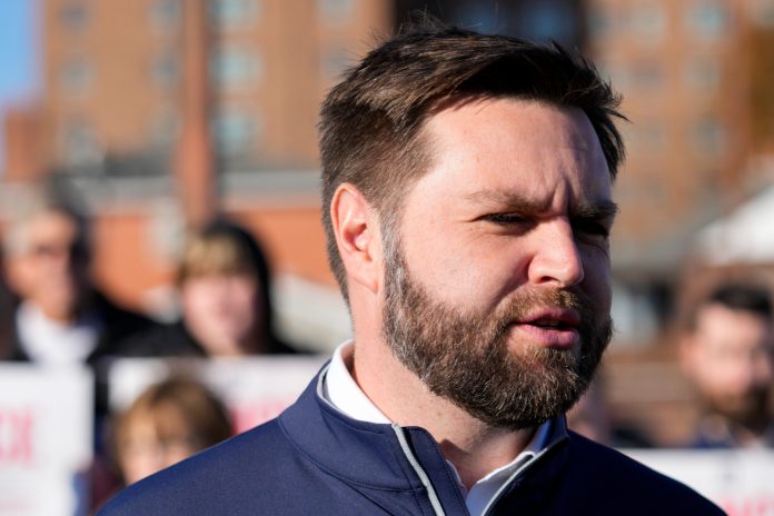 Ohio Senate candidate JD Vance speaks with reporters outside of a polling location in Cincinnati, Tuesday, Nov. 8, 2022. 