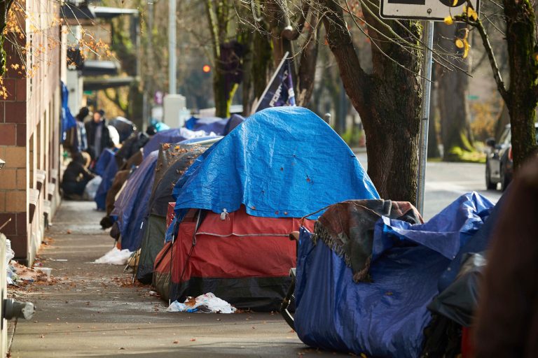 FILE - Tents line the sidewalk on SW Clay St in Portland, Ore., on Dec. 9, 2020. (AP Photo/Craig Mitchelldyer, File)