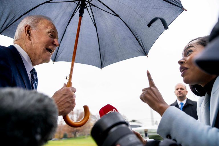 President Joe Biden speaks to a reporter before boarding Marine One on the South Lawn of the White House in Washington, Tuesday, Dec. 6, 2022, to travel to Phoenix.