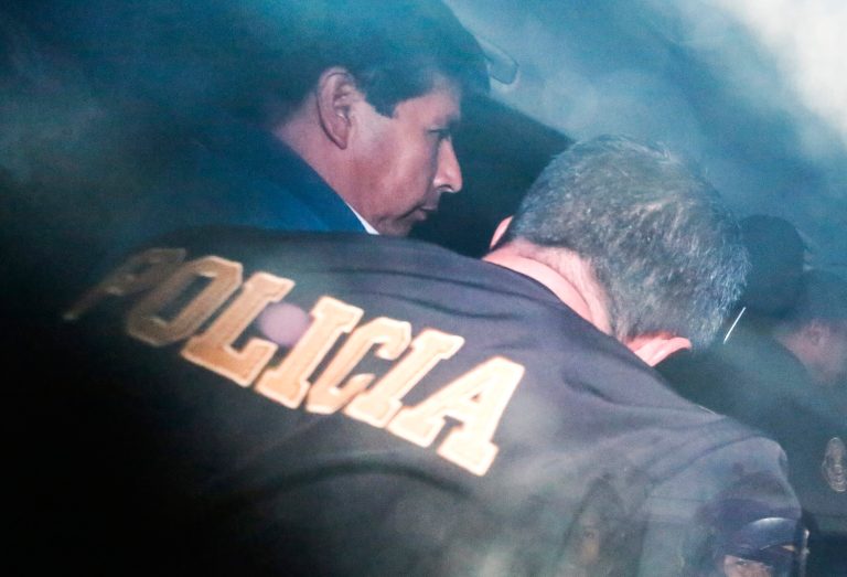 Peru's ousted President Pedro Castillo is escorted by police at the police station where he is being held in Lima, Peru, Wednesday, Dec. 7, 2022.
