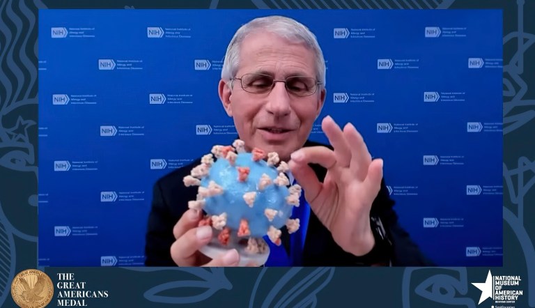 FILE - Dr. Anthony Fauci holding his personal 3D model of the COVID-19 virus he is donating to the Smithsonian's National Museum of American History.