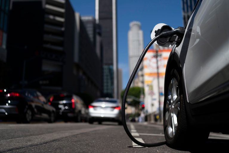 An electric vehicle is plugged into a charger in Los Angeles, on Aug. 25, 2022.  