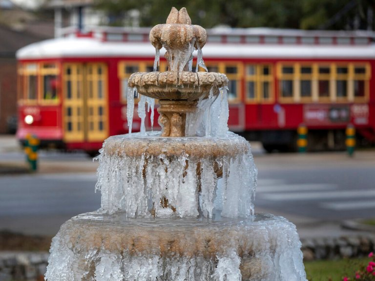 The fountain is frozen as temperatures hovered in the mid 20's at Jacob Schoen & Son Funeral Home in New Orleans, Saturday, Dec. 24, 2022.  