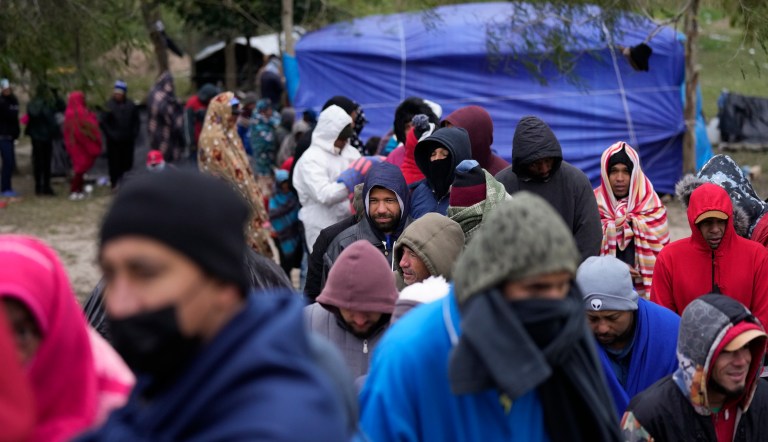 Immigrants from Venezuela line up in the cold weather for hot drinks and food from volunteers at a makeshift camp on the U.S.-Mexico Border in Matamoros, Mexico, Dec. 23, 2022. The Supreme Court is keeping pandemic-era limits on people seeking asylum in place indefinitely, dashing hopes of immigration advocates who had been anticipating their end this week. The restrictions, often referred to as Title 42, were put in place under then-President Donald Trump at the beginning of the pandemic to curb the spread of COVID-19. 