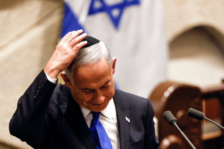 Israeli Prime Minister-designate Benjamin Netanyahu adjusts his skull cap after speaking at a special session of the Knesset, Israel's parliament, to approve and swear in a new government, in Jerusalem Thursday, Dec. 29, 2022. 