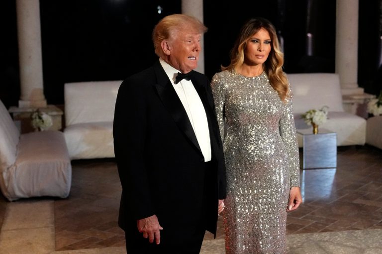 Former President Donald Trump and former first lady Melania Trump stop to speak to the media as they arrive for a New Year's Eve party at Mar-a-Lago, in Palm Beach, Florida, on Saturday, Dec. 31, 2022. 