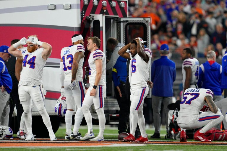 Buffalo Bills players react as teammate Damar Hamlin is examined during the first half of an NFL football game against the Cincinnati Bengals, Monday, Jan. 2, 2023, in Cincinnati. 