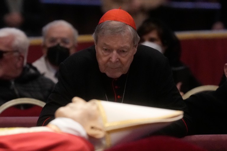 Australian Cardinal George Pell stands next to the body of late Pope Emeritus Benedict XVI lied out in state inside St. Peter's Basilica at The Vatican, Tuesday, Jan. 3, 2023. Pope Benedict, the German theologian who will be remembered as the first pope in 600 years to resign, has died, the Vatican announced Saturday, Dec. 31, 2022. He was 95. 
