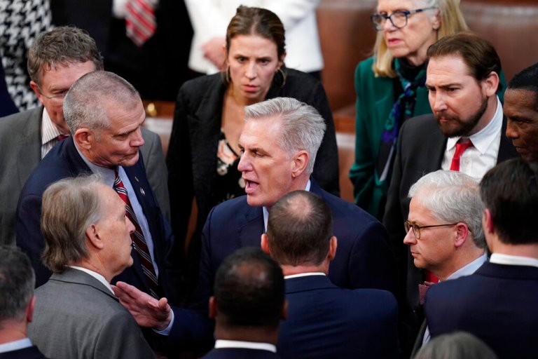 Rep. Kevin McCarthy, R-Calif., talks with colleagues after losing the 14th vote in the House chamber as the House meets for the fourth day to elect a speaker and convene the 118th Congress in Washington, Friday, Jan. 6, 2023.